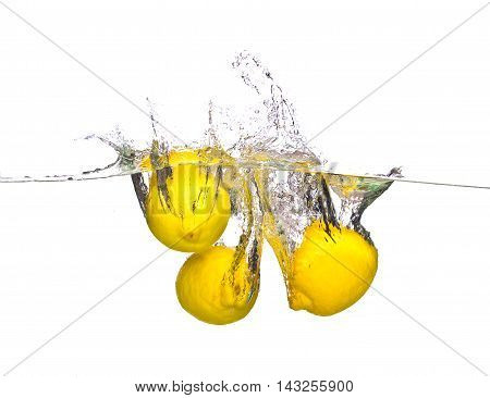 three lemon drop in water on white background