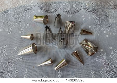 Various metal icing tips for decorating cakes and cookies with frosting