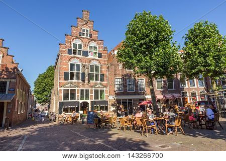OUDEWATER THE NETHERLANDS - AUG 17 2016: People on a terrace in the center of the historical village Oudewater.