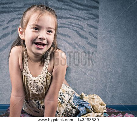 Beautiful aughing girl sitting on the floor