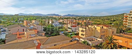 Alcudia Majorca Spain - June 27 2008: Panorama view over residential buildings / homes city of Alcudia towards Tramuntana mountains north of Majorca