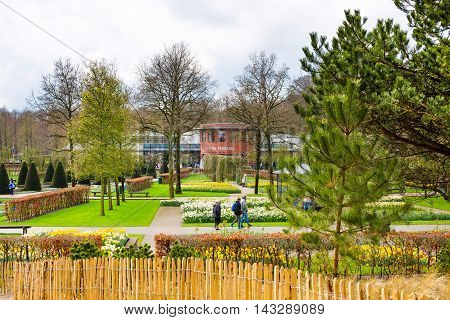 Lisse, Netherlands - April 4, 2016: People walking in dutch spring garden Keukenhof, Lisse, Netherlands