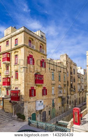 Streetview of Valletta, Malta with red balconies and windows