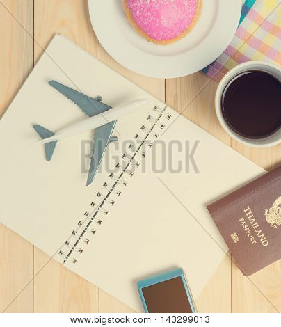 Travel Blank book for vacation planner in cafe with coffee and donut
