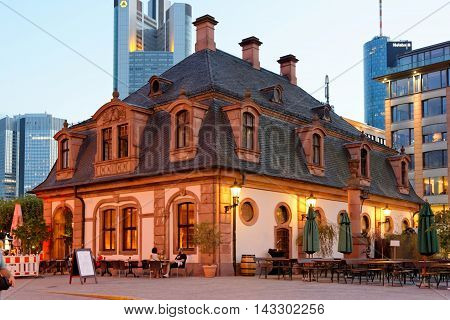 FRANKFURT AM MAIN GERMANY - AUGUST 7 2015: Hauptwache restaurant illuminated in the evenig at Hauptwache plaza a central point and one of the most famous plazas of Frankfurt.
