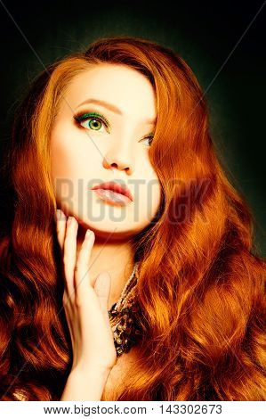 Beautiful woman with curly red hair. Makeup and Hairstyle