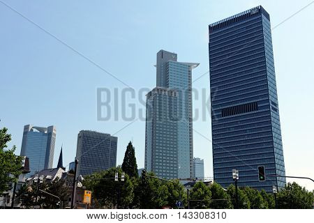 FRANKFURT AM MAIN GERMANY - AUGUST 7 2015: Highrise buidlings left to right Trianon FBC Westend Tower Tower 185. Frankfurt is a dynamic and international financial and trade city with the most imposing skyline in Germany.