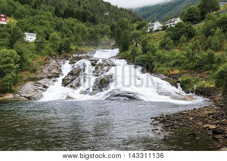 HELLESYLT, NORWAY - JULY 6, 2016: Hellesyltfossen is one of many Norwegian waterfalls in the area Geirangerfjord in village Hellesylt.