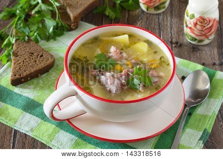 Delicious Rice Soup With Pieces Of Meat And Rye Bread On A Wooden Background.