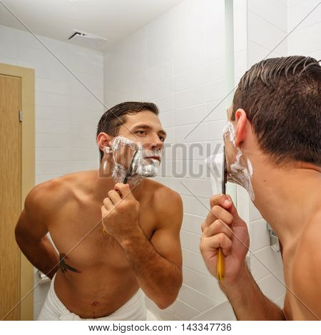 Man shaving straight razor. Man carefully and gently shave with a razor old.
