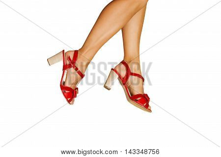 Woman legs with red high heels shoes isolated on white background.