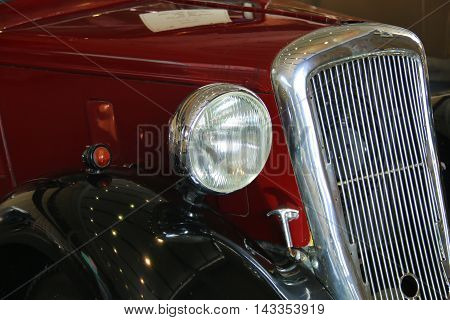 classic car front bumper light and wheel on black. Detail