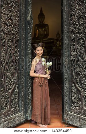 Asian woman wearing typical (Traditional) Thai dress in temple