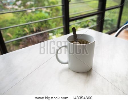 White Tea Cup On The Table At Boh Tea Plantation