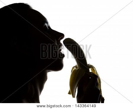 Young amazed woman in lacy lingerie holding a banana, she is going to eat a banana. she sucks a banana.