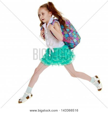 Joyful little girl with long hair to the waist which wire braided white ribbons. In a white shirt without a pattern and green short skirt. Girl jumping over obstacles big step - Isolated