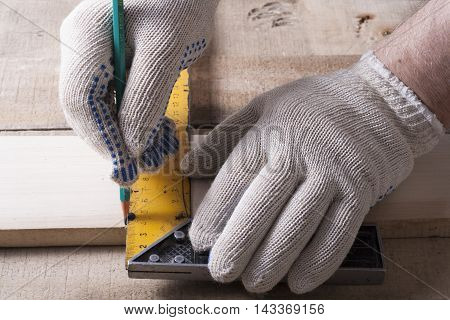 Carpenter working with plane on wooden background at Building Site. Carpenter workplace