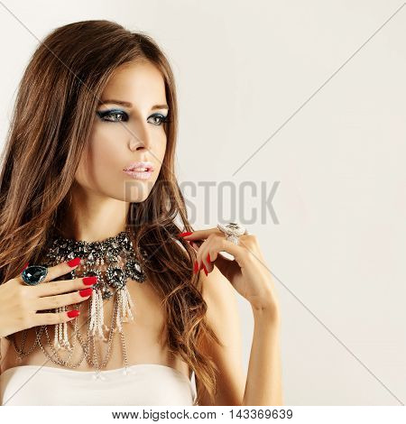 Fashion Woman with Colour Blue Makeup Red Manicure Nails and Jewelry