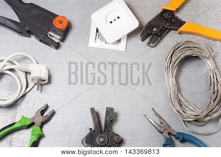 Set of electrical tool on wooden background. Accessories for engineering work, energy concept