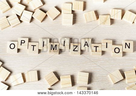 Optinization word written on wood block. Wooden abc.
