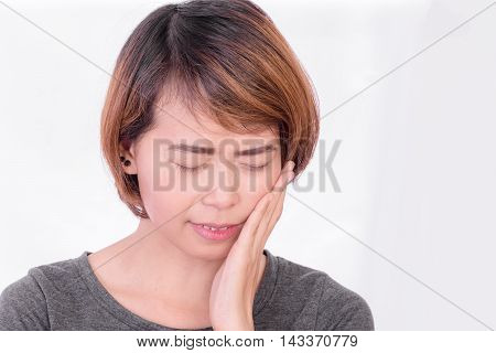 Woman have toothache on white background, symptoms of toothaches typically involve some kind of ache or pain in the jaws or gums