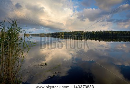 Sunrise on the lake Vuoksa Russia with reflection of clouds
