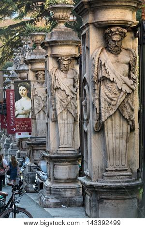 ROME ITALY - JUNE 11 2015: Fencing of Palazzo Barberini (Galleria Nazionale d'Arte Antica) with columns with the image atlantes Rome Italy.