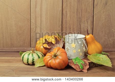 Thanksgiving holiday table decoration with candle and pumpkin
