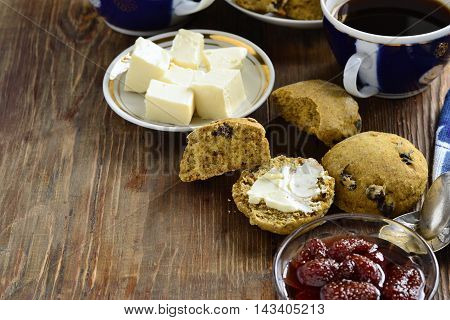 Pumpkin scones with dried fruit for breakfast served with jam and butter