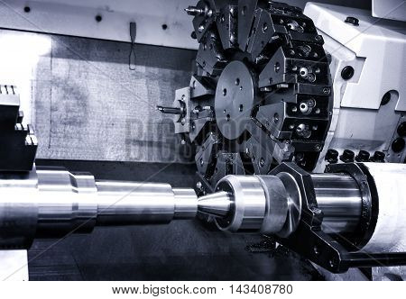 Rotating head with drilling machine bits and tools in high precision mechanics plant at CNC lathe in workshop