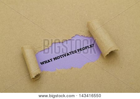 WHAT MOTIVATES PEOPLE? question written under torn paper.