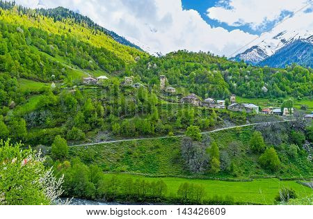 The scenic Bogreshi village on the in Enguri gorge surrounded by green forests Georgia.