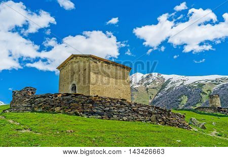 The medieval Jgrag (St George) church surrounded with the stone fence Ushguli Upper Svaneti Georgia.