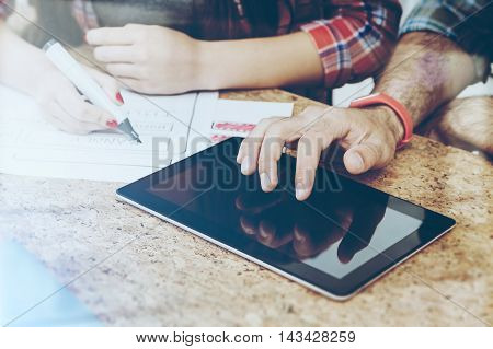 Businessman working with tablet. Woman drawing schemes. Concept of web development. Toned image