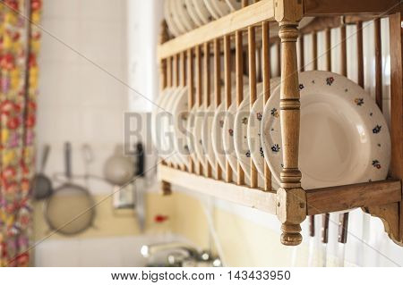 Old wooden plate rack in a cottage kitchen Spain