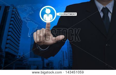 Hand pressing businessman with magnifying glass icon over map and city tower Recruitment concept Elements of this image furnished by NASA