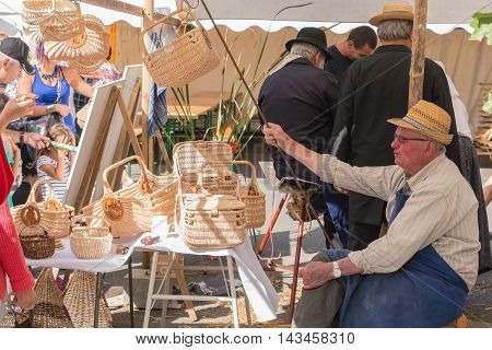 Man Sells Wicker Baskets On A Market