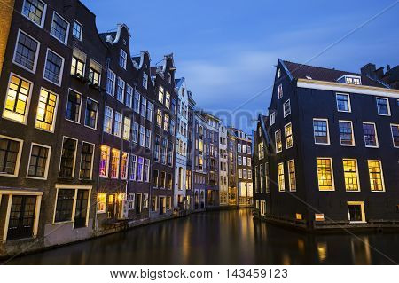 Famous view of Amsterdam canal at night, Netherlands