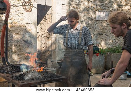 Demonstration By Two Blacksmiths Labor Metal To The Old Way