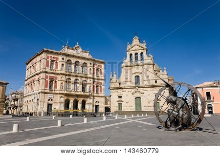 Grammichele Italy - 2015 May 1 : The main square of the Sicilian town of Grammichele with town hall mother church and sundial near Catania Sicily Italy