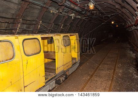 Mine railway in undergroud. Modern coal mine . Real underground post mine illuminated tunnel .