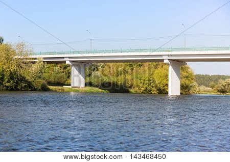 Concrete bridge asross the river at summer