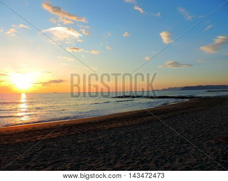 Winter sea at sunsut on soft sand