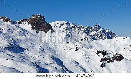 Snow covered mountains and ski slopes in Flumserberg Switzerland.