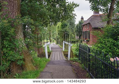 Little white bridge over a canal in the Dutch village of Giethoorn.