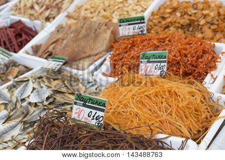 Dried Salted Fish At A Farmers Market. The Price Tags On Each Product With The Title.