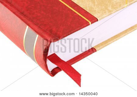 Close de um livro encadernado vermelho e dourado, com fita vermelha do lugar.  Isolado no branco.