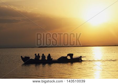small boat across the Albufera at the sunset
