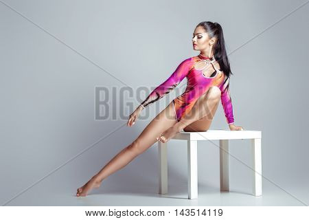 sexy woman in bodysuit with perfect sporty body posing. beautiful gymnast