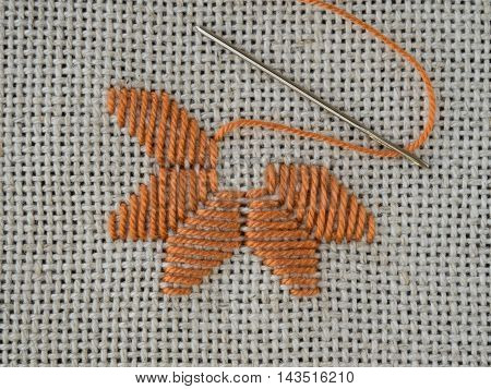 Fragment of embroidery on the canvas with a needle